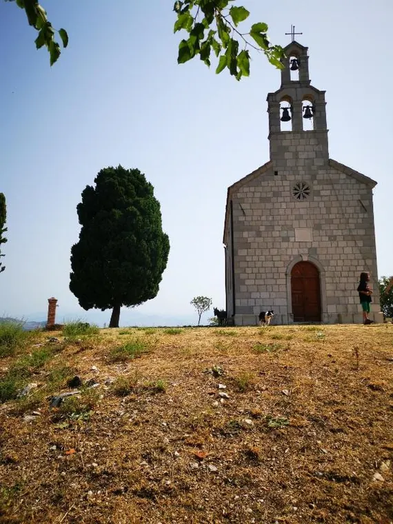 Stone monastery church on a hill above the lake