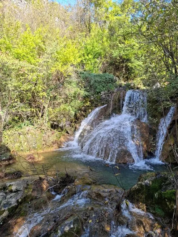 A waterfall flowing down to the lake shore