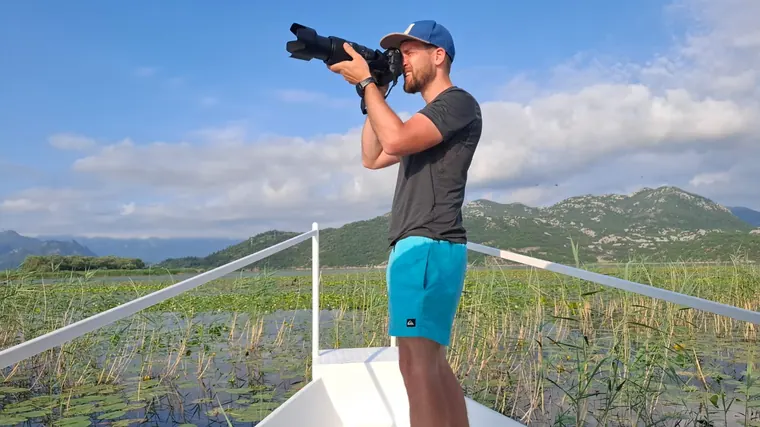 A guest photographing the lily fields