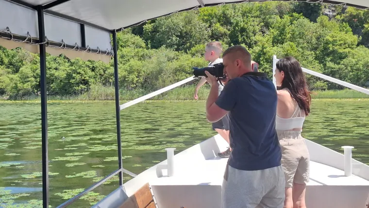 A guest taking in the lake from the boat