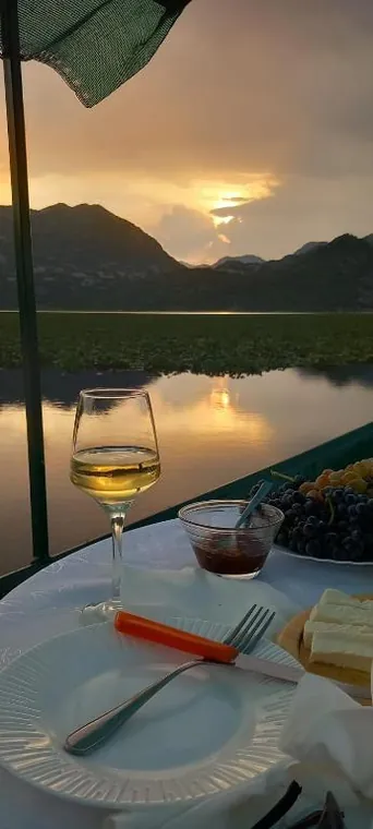 Wine and local food on the boat at golden hour